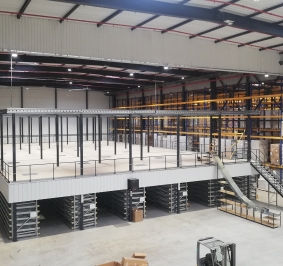 Plataforma de almacenamiento multinivel con estanterías dinámicas y tolva para paquetes
			