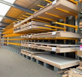 Tableros almacenados en el interior en estanterías cantiléver
			